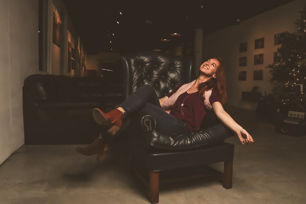 woman sitting in a leather sofa